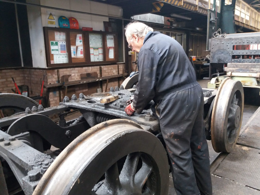 Removing thick oil deposits from the bogie on before it goes for steam cleaning next month 