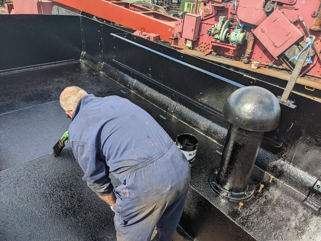 On 7th May Ricky Sault was progressing the bitumen paint that is used to protect the coal space [Photo: Adrian Hassell]