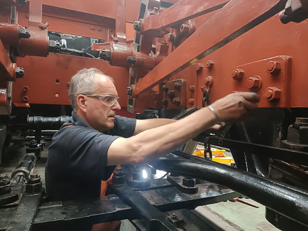 On 20th July, with vacuum brake pipework refitting well underway, Nigel Hanson is seen fitting the drain cock operating linkage. Photo: Chris Field